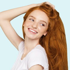Before-styling scene showing Elizabeth Mott primer smoothing and hydrating hair.
