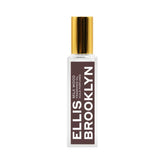 Ellis Brooklyn Milk Wood perfume oil roll-on bottle closeup, highlighting creamy fragrance notes