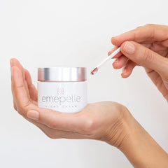 Emepelle Night Cream jar close-up illustrating rich texture for nourishing skin at night.