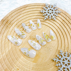 FDSQHSA gold beads and rhinestones provide shimmering accents for upscale nail art.