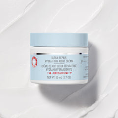 First Aid Beauty night-cream swirl on finger highlights creamy, buttery texture ready for routine.