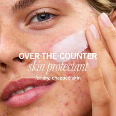 Packaging of First Aid Beauty balm highlighting vegan formula and product details.