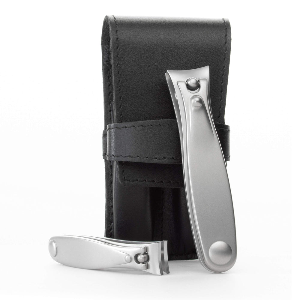 Germanikure nail clippers set in black leather case for travel grooming.