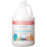 Ginger Lily Farms Champagne Mimosa conditioner bottle pour nourishes and smooths hair.