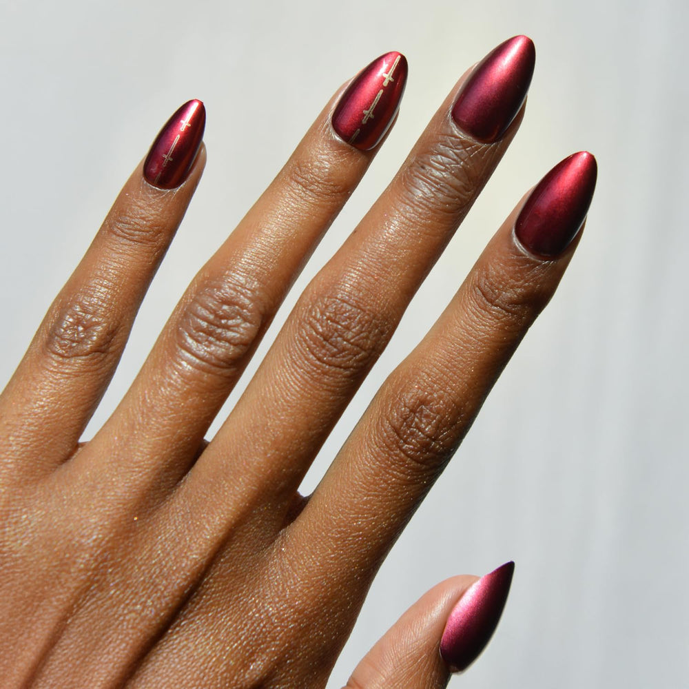 Glamnetic Gryffindor chrome graphic nails closeup with scarlet shine for bold everyday style
