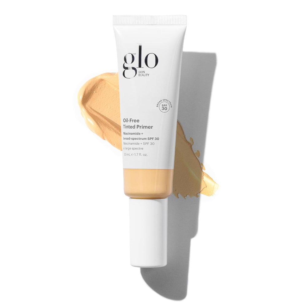 Glo Skin Beauty oil-free tinted primer with SPF 30 in Light Medium bottle provides a breathable base.