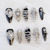 GLORS luxury long almond nails with serpent motif for dramatic evening glam.