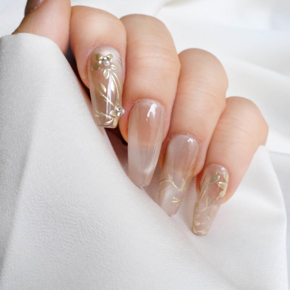 GLORS Nude Press-On Nails in long ballerina shape with gold floral pearls for elegant events