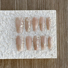 Close-up of pearl accents on GLORS Nude Press-On Nails for delicate sophistication