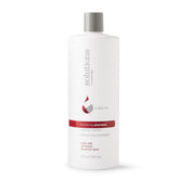 Great Clips Solutions Nourishing Shampoo bottle pour for gentle cleansing and color-safe care.