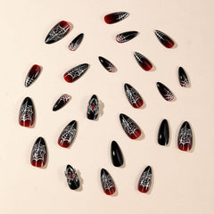 GRITOSE 3D spider accents on luxe black and red nails.