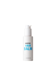 Hairstory Hair Balm bottle close-up highlights glossy moisture for smooth, hydrated hair.