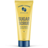 Hand in Hand Sugar Scrub bottle closeup, tropical Island Mimosa scent enhances shower routine and smooths skin.