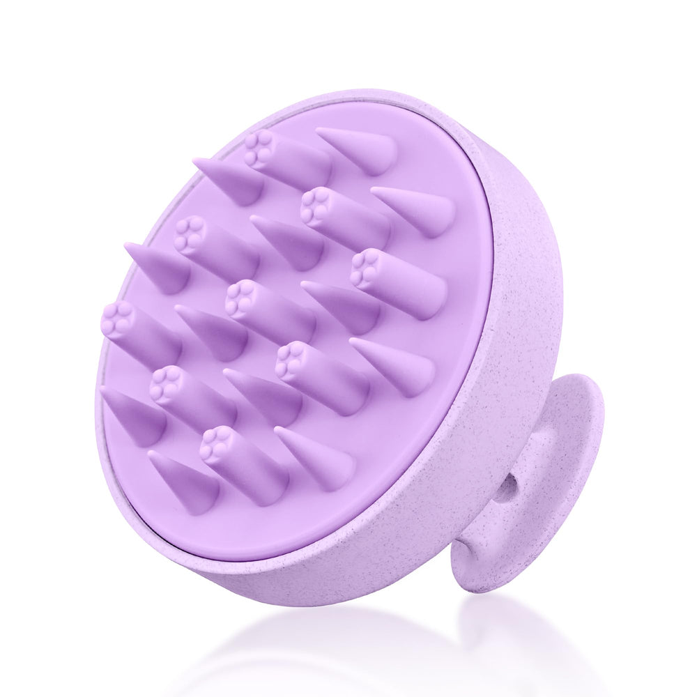 HEETA hair scalp massager in hand with ergonomic non-slip grip for comfortable massage.