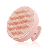 HEETA scalp massager in pink with soft silicone bristles for gentle cleansing.