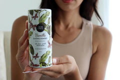 Herb & Root lavender dust powder being brushed onto skin.