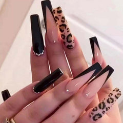 Hkanlre coffin nails with long French leopard rhinestones for a bold salon-style look.