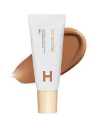 Hourglass Veil Hydrating Skin Tint bottle closeup shows glow and moisture.