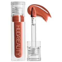 Huda Beauty Faux Filler Extra Shine Foxy bottle highlights hydrating formula for glossy lips.