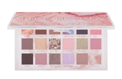 Huda Rose Quartz palette closeup showing rich pigments and smooth texture for blending
