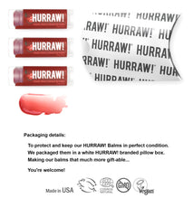 Hurraw White pillow box packaging highlighting the three-pack vegan lip balms.