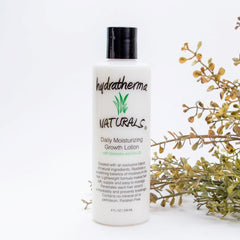 Hydratherma Naturals Daily Moisturizing Growth Lotion bottle pour showing hydration-ready formula