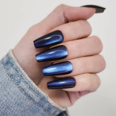 Hypnaughty Stardust Cat Eye coffin nails with blue-purple shimmer for at-home glam.