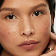 ILIA Banquette shade on lips delivering beige-pink definition and soft-matte finish