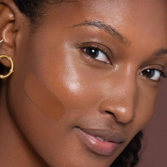ILIA True Skin foundation applicator pump in use for smooth, even coverage.