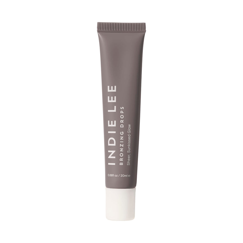 Indie Lee Bronzing Drops on face and body create a natural, hydrating glow.