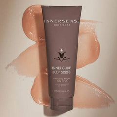 Applying INNERSENSE Inner Glow Body Scrub to damp skin for refreshed texture.