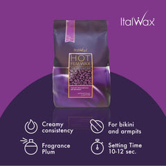 Pouring Italwax Plum hard wax beads to heat for smooth, long-lasting results.