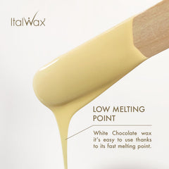 Spatula applying warm Italwax wax for bikini area prep.