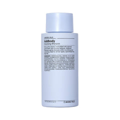 J Beverly Hills Blue Addbody shampoo bottle on bathroom shelf for volumizing cleanse