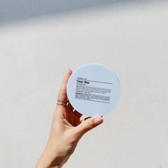 Hands applying wax on damp hair for flexible hold.