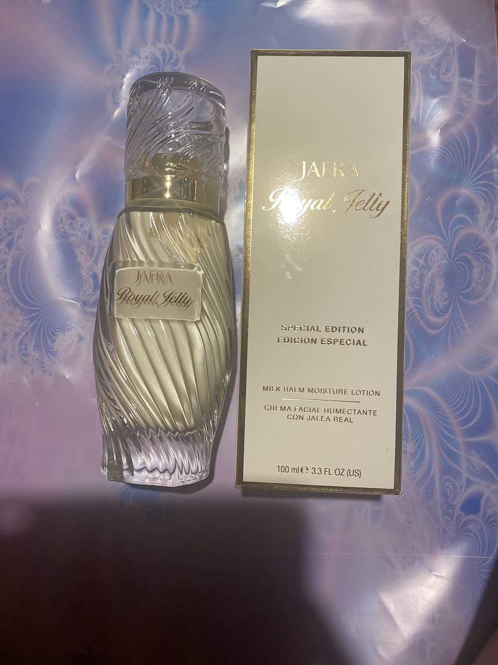 JAFRA Royal Jelly Milk Balm Advanced bottle pour shows luxurious texture and daily hydration.