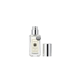 Jo Malone Wood Sage & Sea Salt deluxe sample bottle on a vanity, travel-ready.