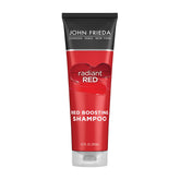 John Frieda Radiant Red Shampoo bottle on sink for vibrant red hair color.