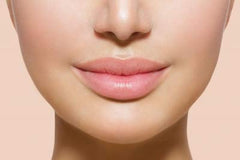 Jolie Vitamin E Lip Conditioner Stick in use to hydrate and soften creases.