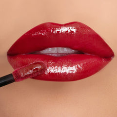 K7L Hustle red lip gloss tube close-up with rich color payoff.