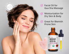 Pink gua sha stone alongside rosehip oil kit for hydrating facial massage sessions.