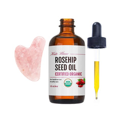 Kate Blanc Rosehip Oil bottle with pink gua sha stone for smooth facial massage.