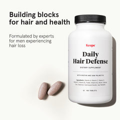 Close-up of Keeps hair growth tablets ready for a simple daily dose.