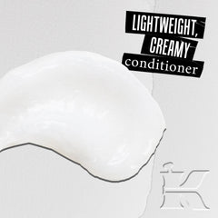 Kiehl's leave-in conditioner application on hands prepares hair for detangling.