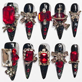 KimKista handmade stiletto nails in black with red rhinestones for dramatic Gothic style
