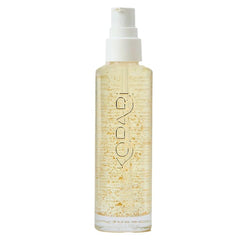 Kopari Golden Aura bottle closeup displays 24K gold glow for radiant skin.
