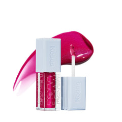 Kosas Wet Lip Oil Gloss bottle close-up showing hydrating shine on lips.