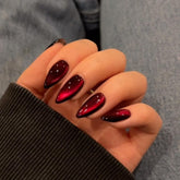 KQueenest Dark Red Cat Eye nails for dramatic evening looks.