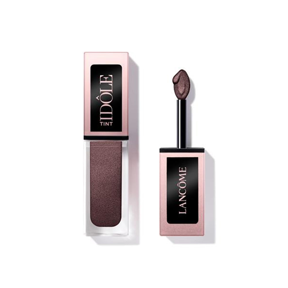 Lancôme Idôle Tint bottle close-up with iridescent warm brown shade for versatile looks.