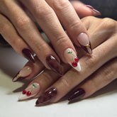 Lankensuixi long almond press-on nails in burgundy nude with gold studs for elegant evenings